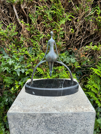 Escultura em bronze de uma mulher sentada num arco num planalto de mármore - Moderna - Elegante - Intemporal - Escultura