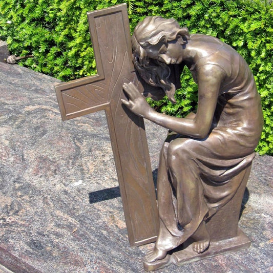 Lady sitting next to the cross 57x19x44cm